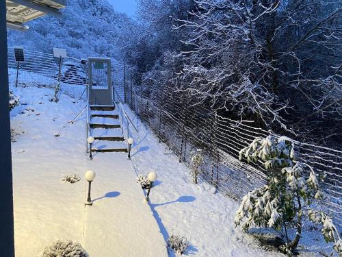 a snow covered yard with a ladder and a fence at Dryades in Elati