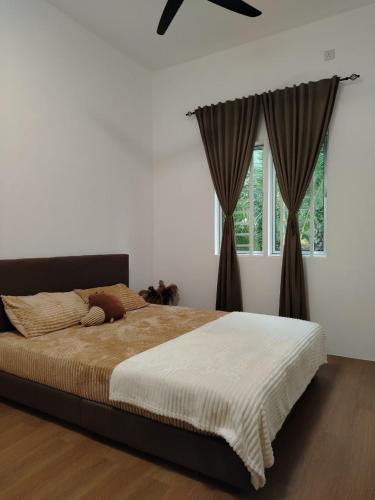 a bedroom with a large bed and a window at Risfeena Home in Sekinchan
