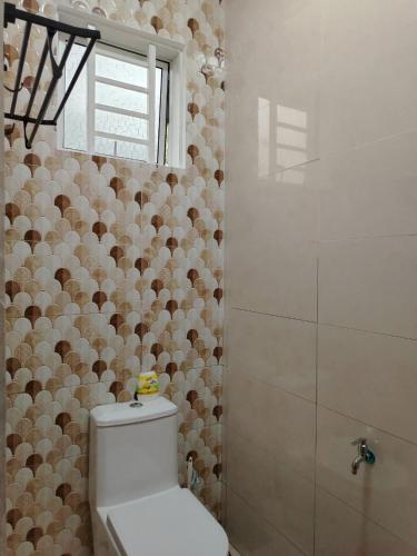a bathroom with a toilet and a shower at Risfeena Home in Sekinchan
