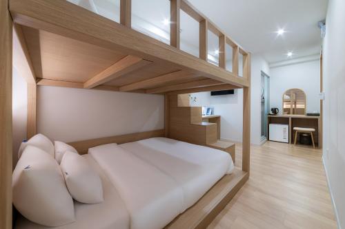 a bedroom with a loft bed with white pillows at Hi Seoul Hostel Central in Seoul