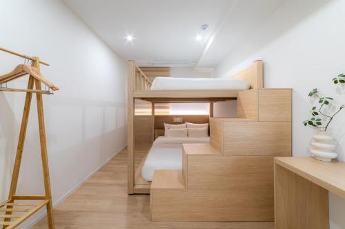 a room with two bunk beds and a ladder at Hi Seoul Hostel Central in Seoul