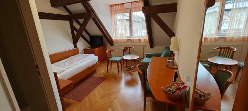 a living room with a couch and a table and chairs at Gästehaus Einzinger in Krems an der Donau