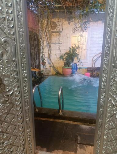a reflection of a pool in a mirror at FM Homestay Banyuwangi in Banyuwangi