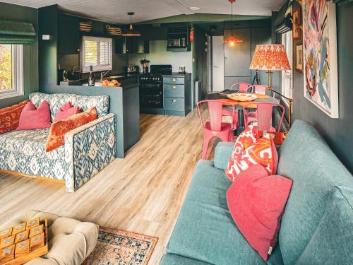 a living room with a blue couch and a table at The Herdsman - Uk50615 in Sabden
