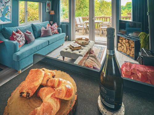 a living room with a bottle of wine and a table with bread at The Herdsman - Uk50615 in Sabden