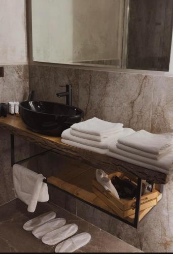 a bathroom with a counter with a sink and towels at Valley Park Dilijan in Dilijan
