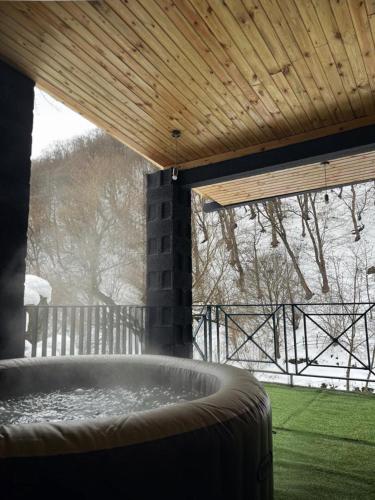 a hot tub in a porch with a view of the snow at Valley Park Dilijan in Dilijan