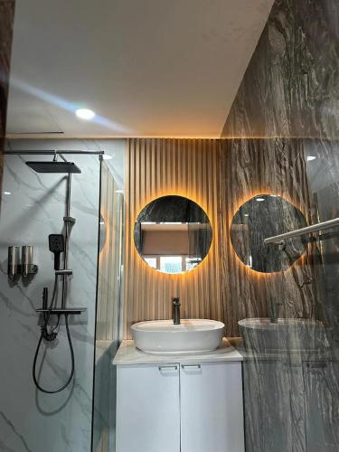 a bathroom with a sink and a shower at Puttaya Glow in Pattaya
