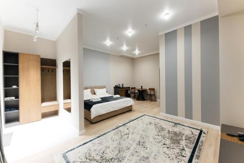 a bedroom with a bed and a rug at AURA hotel in Taraz