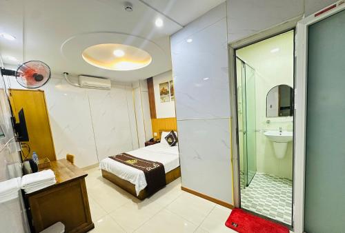 a bathroom with a bed and a glass shower at KHÁCH SẠN PHÚ HƯNG in Ho Chi Minh City