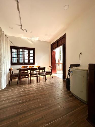 a kitchen and dining room with a table and chairs at Ovana Homestay in Phan Thiet