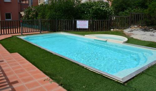 a swimming pool in the grass in a yard at Corsappart in Porto-Vecchio