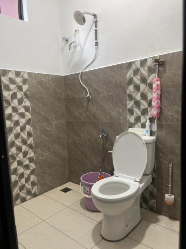 a bathroom with a toilet and a shower at Homestay Anjang in Tapah
