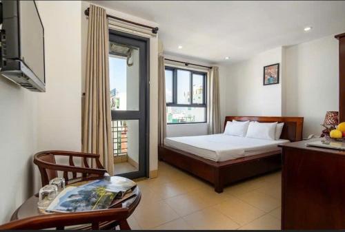 a bedroom with a bed and a window at Lotus Rock Hotel Đà Nẵng in Danang