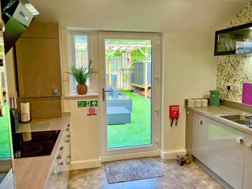 a kitchen with a door leading to a yard at Station View in Pickering