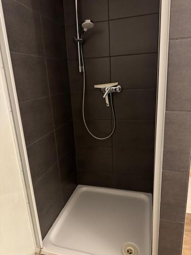 a shower with a shower head in a bathroom at City Room 2 Stuttgart-Mitte in Stuttgart