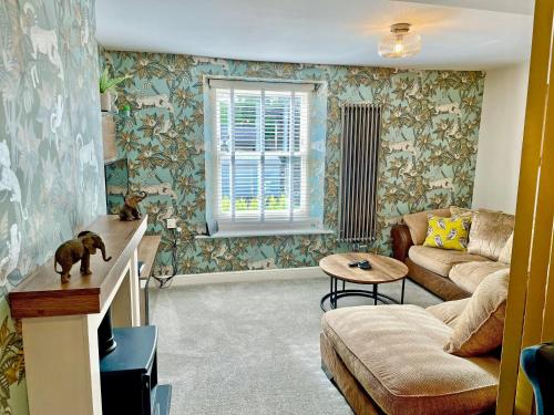 a living room with a couch and a table at Station View in Pickering