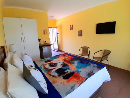 a bedroom with a dog blanket on a bed at Meerkat Manor on Main in Clarens