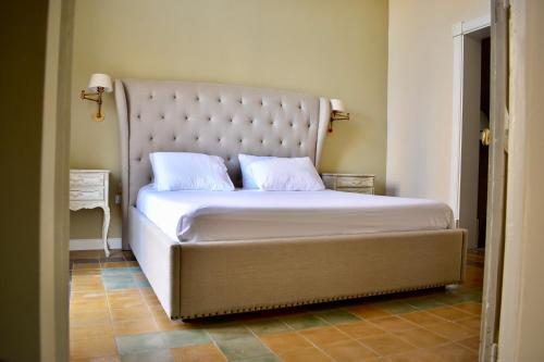 a bedroom with a large bed with a large headboard at Grand Arcanum Apartment 2 - Comfortable and Elegant in Senglea