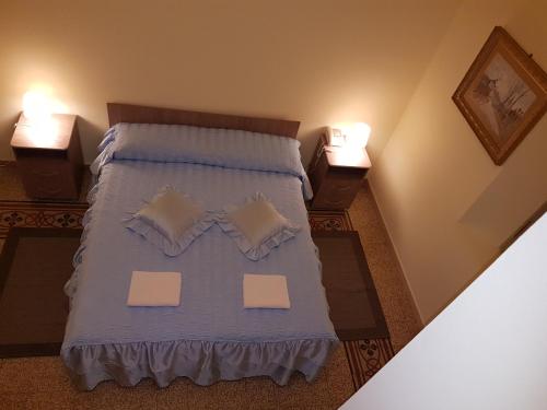 a bedroom with a bed with two lamps on it at Villa Alba in Pisa