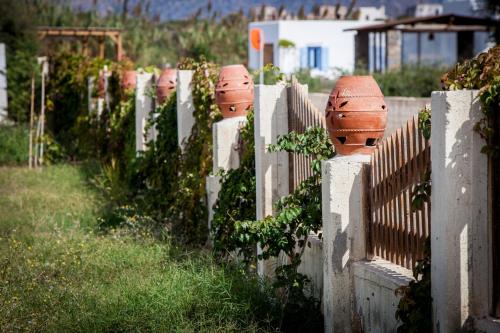 a fence with clay pots on top of it at Athina Studios and Suites Plaka in Plaka