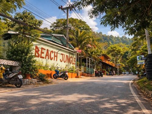 a street in a town with motorcycles parked on the side at Beach Jungle in Ko Chang