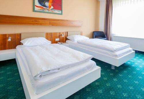 Ένα ή περισσότερα κρεβάτια σε δωμάτιο στο Hotel & Restaurant Ernst