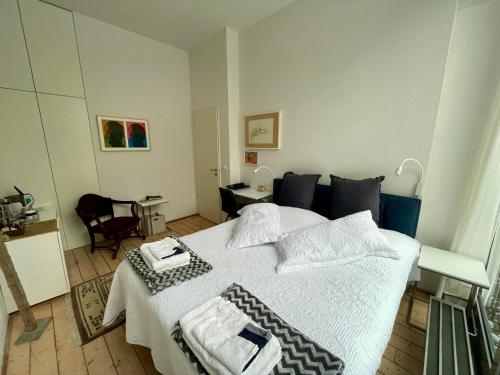 a bedroom with a large bed with towels on it at Room Art Lovers in Marmagen