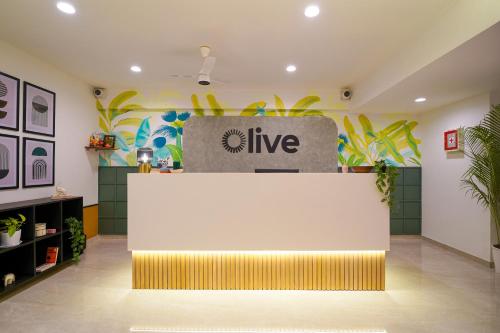 an office with a live sign on the wall at Olive Hotel Wakad by Embassy Group in Pune