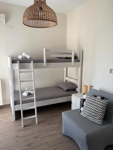 a room with two bunk beds and a couch at Elena's House in Methana