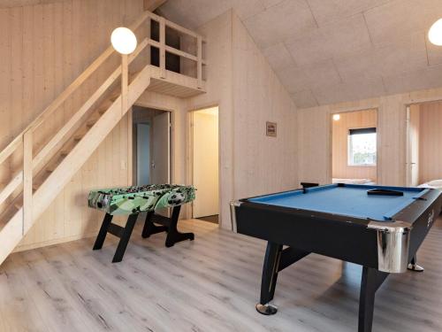 a pool table in a room with a staircase at 22 person holiday home in Jerup in Jerup