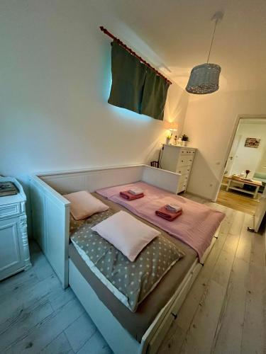 a small bedroom with a bed with two pillows on it at Gesztenyeház guest house with hot tub in Leányfalu