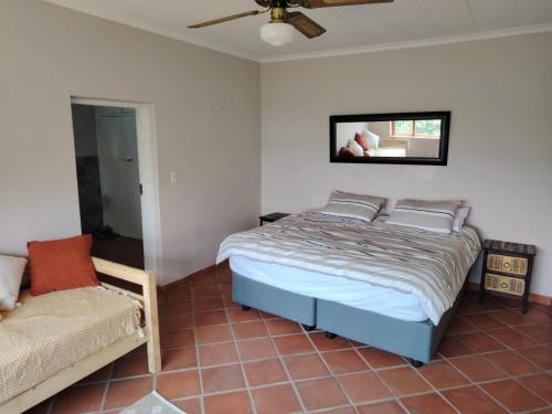 a bedroom with a bed and a couch at Wakanda on Hartbeespoort Dam in Hartbeespoort