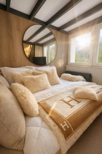 a bedroom with a large bed with a large mirror at Ma Montagne Chic 4 in La Bresse