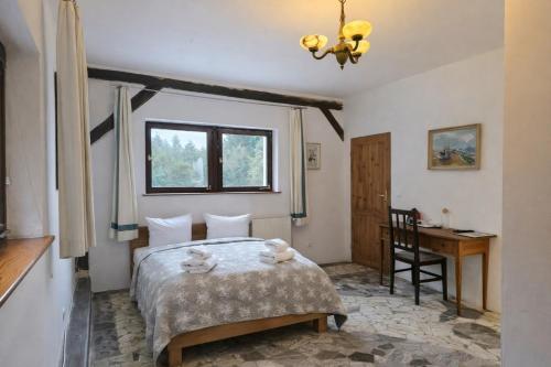 a bedroom with a bed with two stuffed animals on it at Dworek Adamski in Wałbrzych