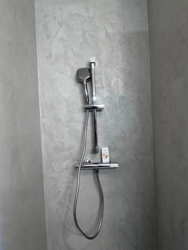 a bathroom with a blow dryer on a wall at Loveroom Montargis in Montargis
