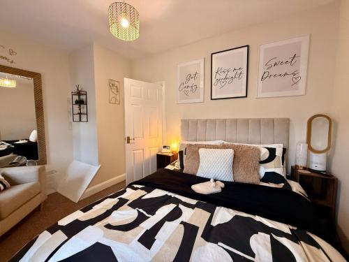 a bedroom with a large bed and a couch at 2 Bedroom House By Travel Lets Holiday Homes Derry With Garden in Derry Londonderry