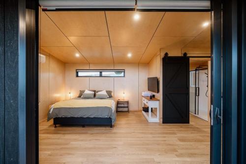 a bedroom with a bed and a tv in a room at Casa Olea in Waipara