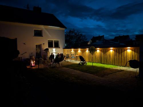 a group of people standing outside a house at night at Ferienhaus "Fritz" mit 3 Schlafzimmern in Seenähe in Löbnitz