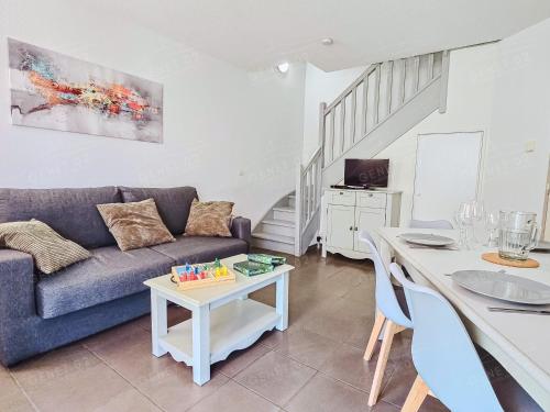 a living room with a couch and a table at Maison de vacances près du Mont Ventoux in Aubignan