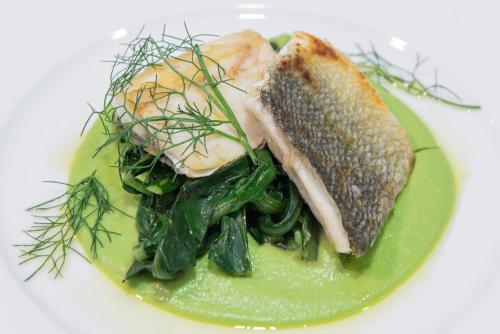 a plate of food with fish and vegetables on a plate at Idea Hotel Torino Mirafiori in Turin