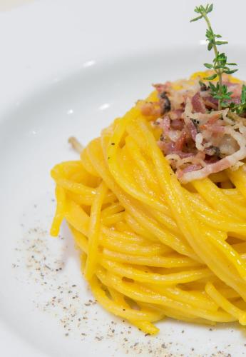 a plate of pasta with meat on top of it at Idea Hotel Torino Mirafiori in Turin