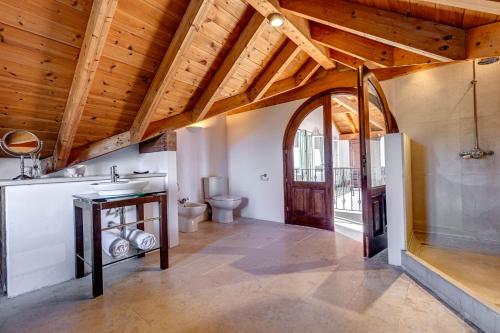 a bathroom with a sink and a toilet at Eagle's Rest Villa in Kassiopi