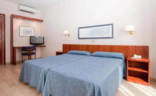 Ένα ή περισσότερα κρεβάτια σε δωμάτιο στο Peninsular