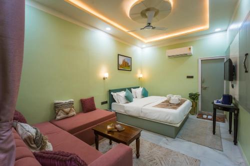 a hotel room with a bed and a couch at Shri Prem Villa in Jaisalmer