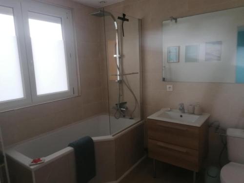a bathroom with a tub and a sink and a shower at l'auberge des trois lieux in Calais