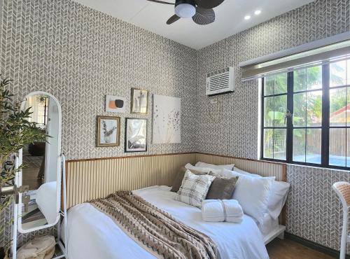 a bedroom with a bed and a window at Soak Screen Urban Hideaway in Iloilo City