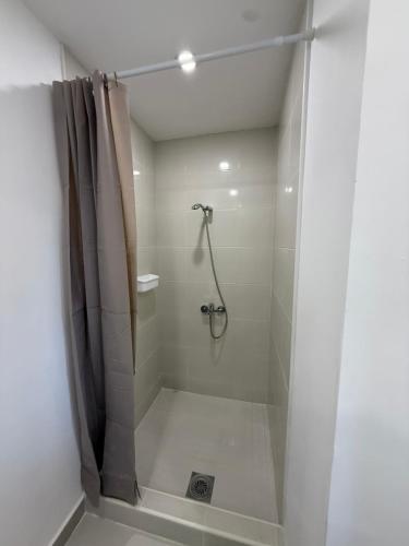a bathroom with a shower with a shower curtain at La Belle Saison in Briska Gora