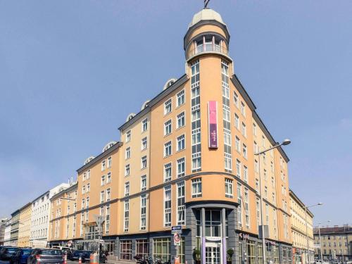 a building with a clock tower on top of it at Hotel Mercure Wien Westbahnhof in Vienna