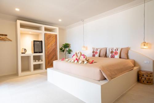 a bedroom with a large bed and a television at Relax Bay Beach Resort in Ko Lanta